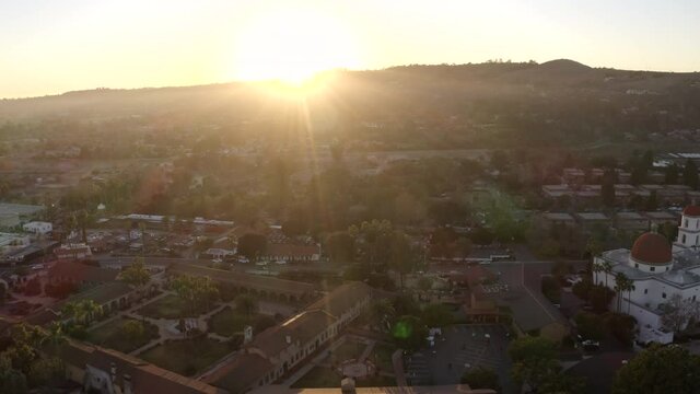 Sunset aerial view of the Spanish Colonial era mission and surrounding city of downtown San Juan Capistrano, California, USA. 