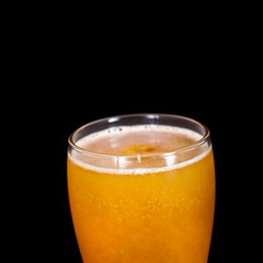 Glass of craft beer with passion fruit isolated on a black background.