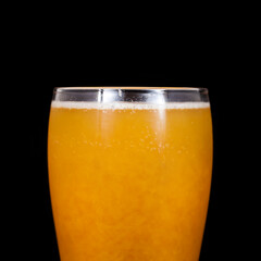 Glass of craft beer with passion fruit isolated on a black background.