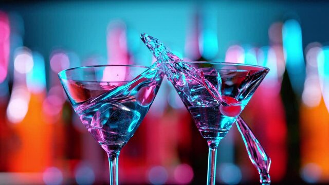 Super Slow Motion of Martini Cocktails Hitting Together in a Bar, Cheers Concept. Filmed on High Speed Cinema Camera