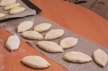 Russian pies made of raw dough stuffed with cabbage. Homemade baking
