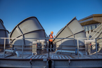 Engineer under checking the industry cooling tower air conditioner is water cooling tower air...