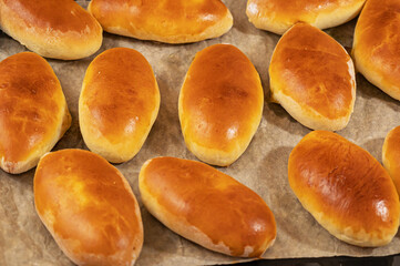 Oven-baked Russian pies stuffed with potatoes and cabbage. Home hobby