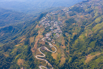 Aerial view of cars driving on curved, zigzag curve road or street on mountain hill with green...