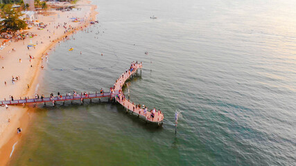 Aerial view of Sunset in Phu Quoc beach with nice view. Tourists, sunbeds and umbrellas on beautiful day in Sanato beach, Phu Quoc island, Vietnam