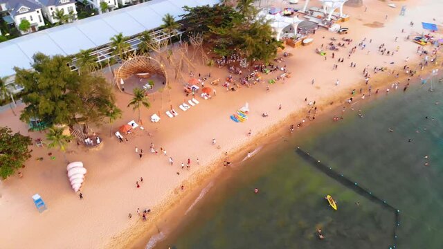 Aerial view of Sunset in Phu Quoc beach with nice view. Tourists, sunbeds and umbrellas on beautiful day in Sanato beach, Phu Quoc island, Vietnam