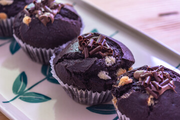 Chocolate muffins with crispy top.
