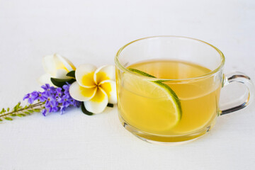 herbal healthy drinks ginger ,lemon cocktail water with purple flower ,frangipani decoration flat lay style on background white 