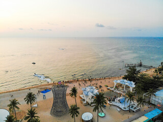 Aerial view of Sunset in Phu Quoc beach with nice view. Tourists, sunbeds and umbrellas on beautiful day in Sanato beach, Phu Quoc island, Vietnam