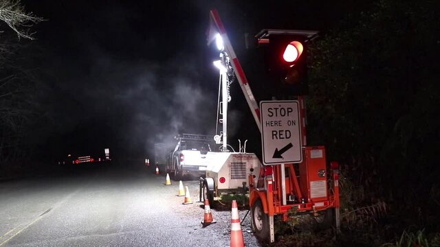 View of sign Stop Here On Red due to A major upgrade to Highway 4 at Kennedy Hill northeast of the Tofino-Ucluelet Highway 4 junction.
