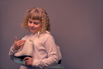 Figure skater with skates in her hands. Close-up portrait of a girl.