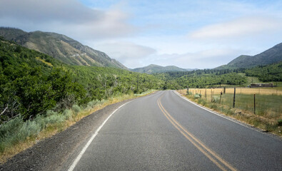 Cloudy sky with the road on a warm summer day in the Uinta National Forest in Utah