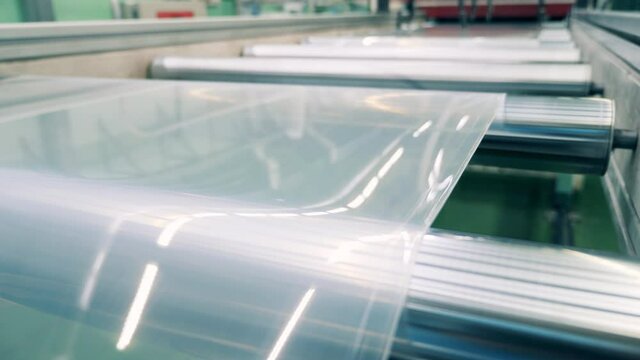 Close up of plastic sheet going through the factory transporter