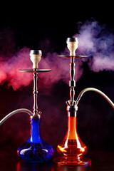 Modern hookah with smoke in dark club light