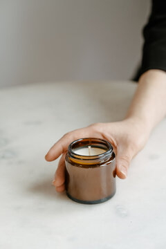 Candle in brown glass on white minimalist product photo