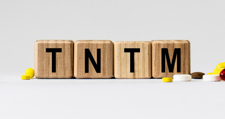 cubes with the word TNTM on them. Care concept