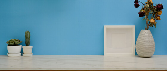 Marble desk with mock up frame, plant pots and flower vase in home office room