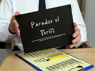 Business concept about Paradox of Thrift with phrase on the sheet.