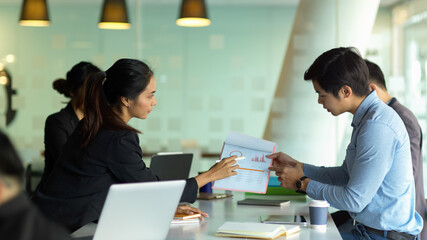 Businesspeople meeting on their business project in glass partition meeting room