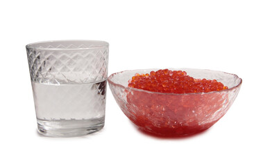 Red caviar lies in glass bowl and vodka. Isolated object on a white background