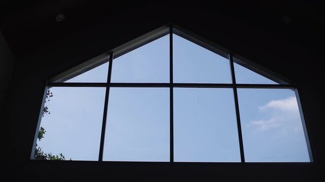 Framing blue sky and litte cloud from inside home building with moving camera tracking