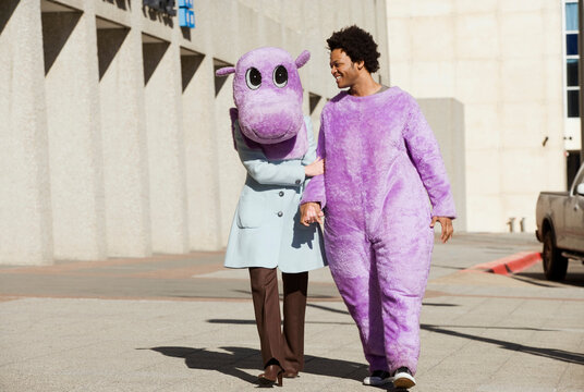Couple walking down the street wearing a hippo costume