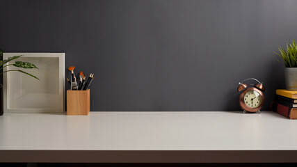 Workspace with study table with copy space, stationery, books and decorations