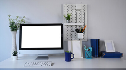 Stylish workplace with mock up computer and office supplies on white table.