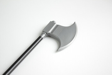 Plastic miniature model of pick axe with black handle. Toy ax isolated white background. 