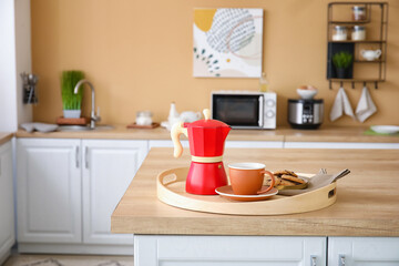 Tray with cezve, cup of coffee and cookies on kitchen counter