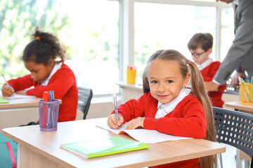 Cute children during lesson in classroom
