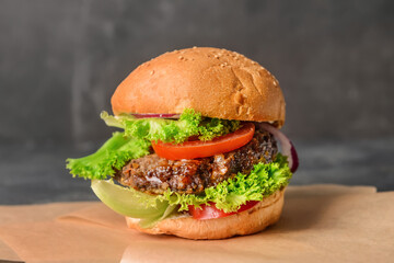 Tasty burger on dark background