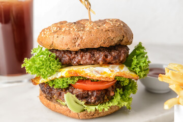 Tasty burger on light background