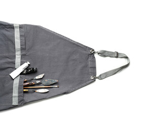 Apron and set of artist's supplies on white background