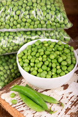 fresh green pea in bowl on wooden background