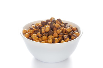 Crunchy Roasted Chana Masala in a white bowl, made with Bengal Grams or Chickpeas. Pile of Indian spicy snacks (Namkeen). Side view, against the white background