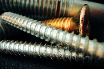 Iron screw bolts on black background close up