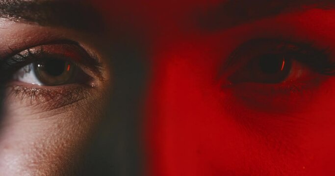 Close up of woman's beautiful eyes with red light