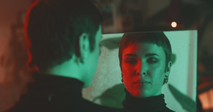 Caucasian woman looking at camera through the reflection on a old mirror