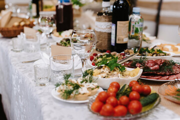 glasses for wine and drinks on the laid festive table in the restaurant