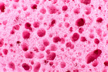 Pink sponge texture background. Close up, macro photo.