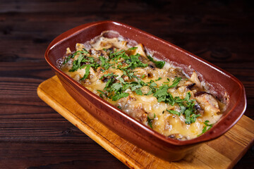 Baked meat with mushrooms and cheese. Al forno. Close-up, selective focus