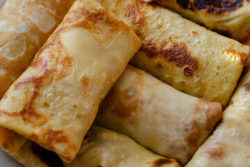 Blini, Shrovetide. Close-up of traditional homemade crepes stuffed with various fillings.