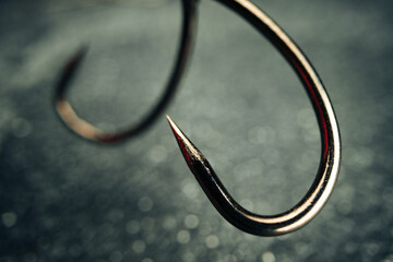Macro photo of fishing hook on grey background