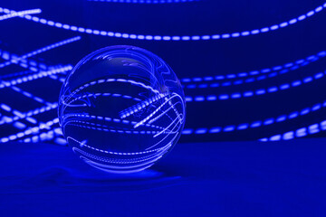 A transparent glass ball with reflection for design. Abstract Light Painting. Dark neon background.