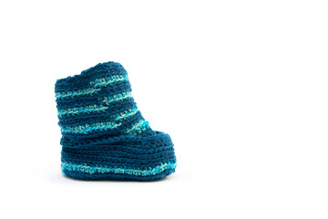 Handmade knitted shoes for small children. Adorable newborn baby shoes isolated on white background.
