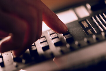 Close-up of a man's hand dialing a phone