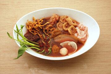 Yentafo noodle in the bowl put on black background asia food the fresh healthy food, Asian Thailand noodle with red water fish meatball and tofu.