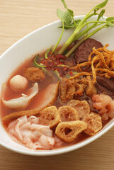 Yentafo noodle in the bowl put on black background asia food the fresh healthy food, Asian Thailand noodle with red water fish meatball and tofu.
