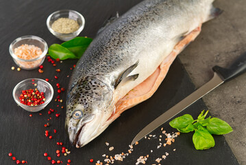 Salmon with spices on a blackstone board. Macro shot.